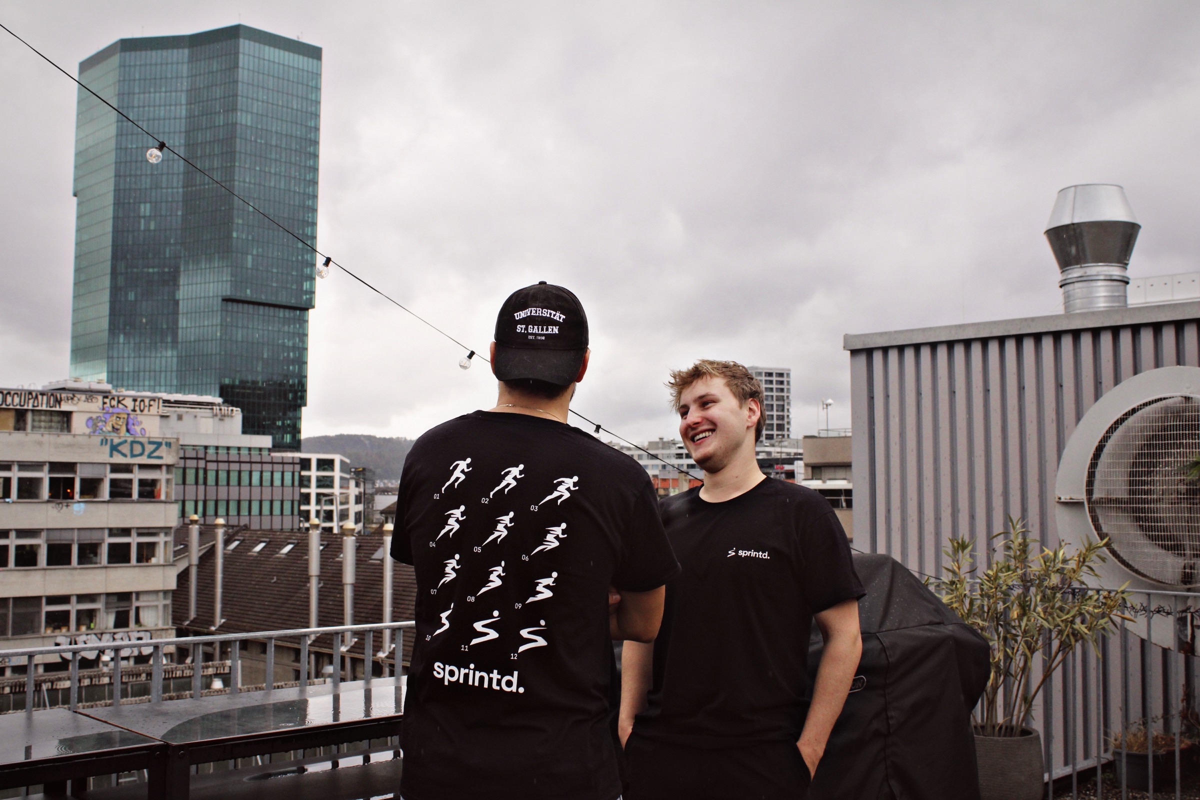 The two sprintd co-founders on a rooftop in Zurich, one in a sprintd back-print shirt.